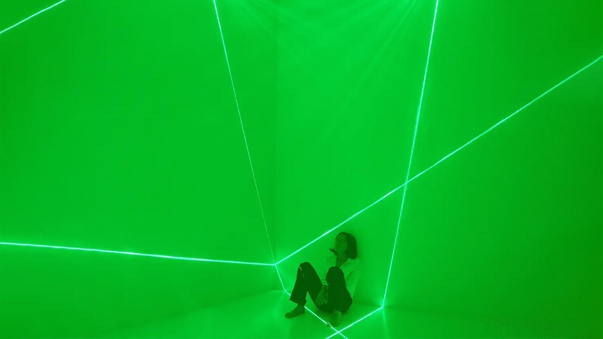 A photo of the artist is framed within the luminous planes projected against the walls at Jack Straw Gallery in Seattle