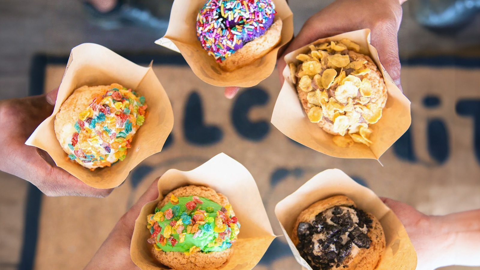 Ice cream puffys topped with Fruity Pebbles, Oreos, Corn Flakes, and sprinkles. 