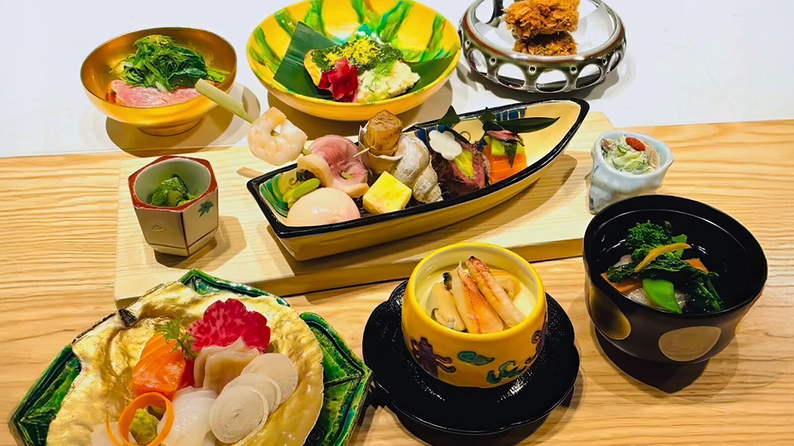 Assorted Japanese dishes beautifully arranged on a table, featuring sushi, sashimi, tempura, and various side dishes in elegant ceramic bowls and plates—a tasteful nod to Seattle’s restaurant-scape which is still sleepily waking up with enticing new restaurant openings.