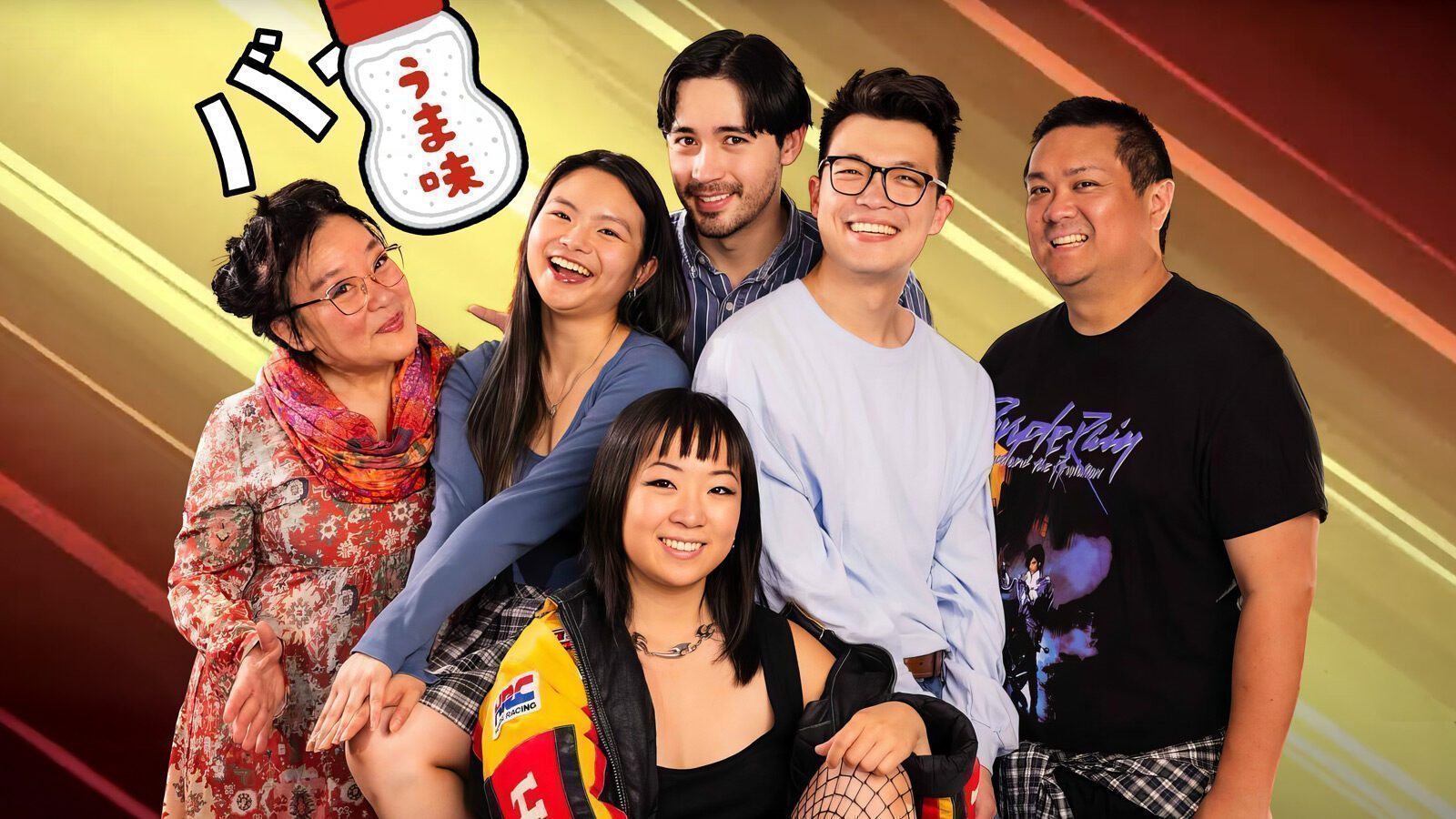Six people pose together in front of a colorful, diagonal-striped background with a Japanese snack graphic in the top left corner—perfect for those seeking what to do in Seattle or exploring the vibrant Seattle arts scene.