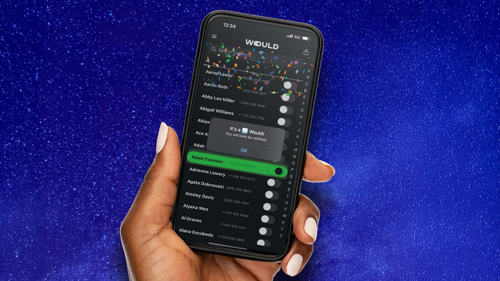 A hand holds a smartphone displaying the "WOULD" app with a notification congratulating the user on winning, set against a blue starry background—perfect for fans of online dating and exploring new dating apps.