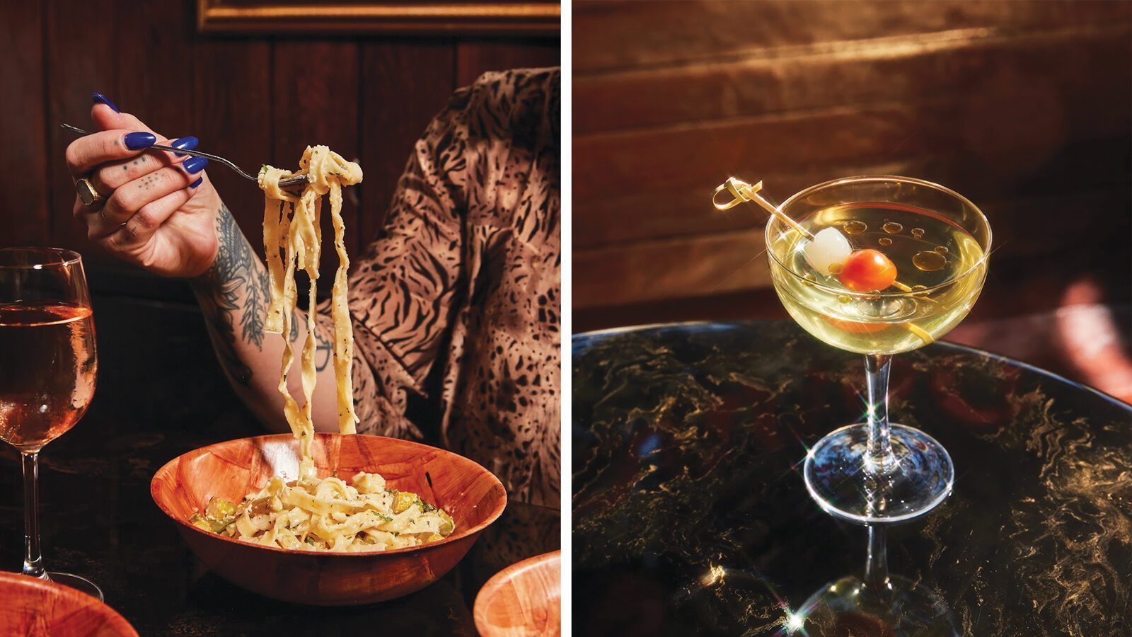 A person with tattoos and blue nails lifts pasta from a wooden bowl at Donna’s; beside it, a martini with olives and an onion garnish rests on the dark tabletop of this moody bar.